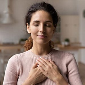 mujer con la mano en el pecho