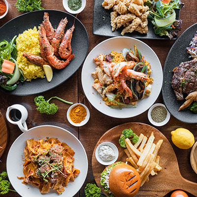 Variedad de platos con papas fritas, hamburguesas y carnes que representan lo que no comer con hígado graso